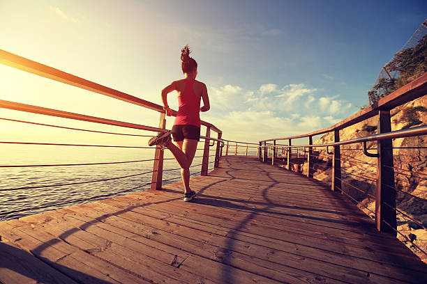 woman running on boardwalk down by the water